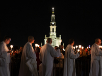 Pilgrims hold candles and pray during the candle procession at the Sanctuary of Fatima, in Fatima, Portugal, on October 12, 2024, on the ann...