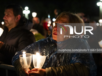 Pilgrims hold candles and pray during the candle procession at the Sanctuary of Fatima, in Fatima, Portugal, on October 12, 2024, on the ann...