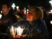 Pilgrims hold candles and pray during the candle procession at the Sanctuary of Fatima, in Fatima, Portugal, on October 12, 2024, on the ann...