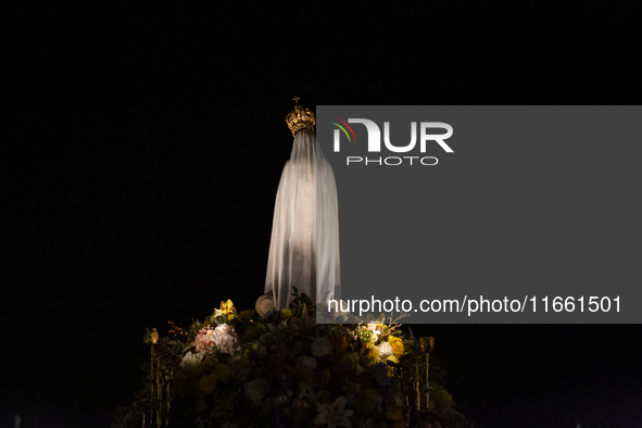 Pilgrims hold candles and pray during the candle procession at the Sanctuary of Fatima, in Fatima, Portugal, on October 12, 2024, on the ann...