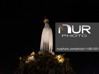 Pilgrims hold candles and pray during the candle procession at the Sanctuary of Fatima, in Fatima, Portugal, on October 12, 2024, on the ann...