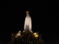 Pilgrims hold candles and pray during the candle procession at the Sanctuary of Fatima, in Fatima, Portugal, on October 12, 2024, on the ann...