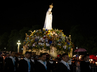 Pilgrims hold candles and pray during the candle procession at the Sanctuary of Fatima, in Fatima, Portugal, on October 12, 2024, on the ann...