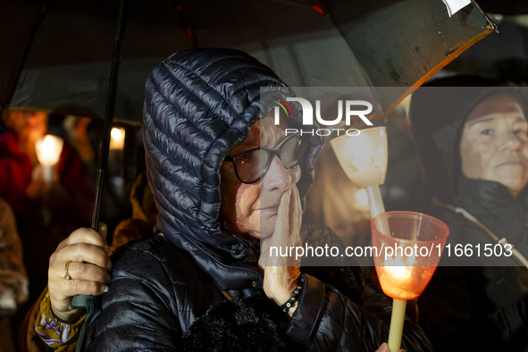 Pilgrims hold candles and pray during the candle procession at the Sanctuary of Fatima, in Fatima, Portugal, on October 12, 2024, on the ann...