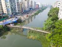 An aerial view shows hundreds of people in Dhaka, Bangladesh, using the makeshift bamboo bridge over the canal at Banasree in the capital ci...