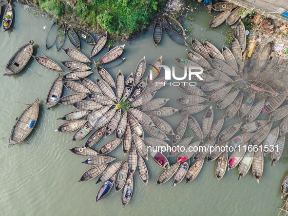 An aerial view shows wooden passenger boats along the Buriganga River in Keraniganj, Dhaka, Bangladesh, on October 13, 2024. The boats, deco...