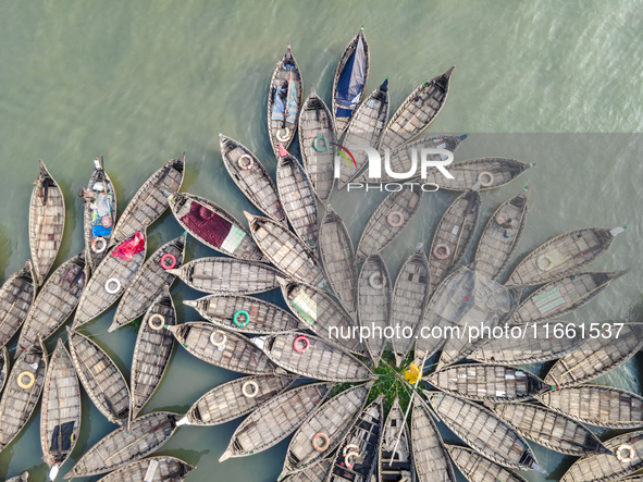 An aerial view shows wooden passenger boats along the Buriganga River in Keraniganj, Dhaka, Bangladesh, on October 13, 2024. The boats, deco...