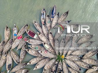 An aerial view shows wooden passenger boats along the Buriganga River in Keraniganj, Dhaka, Bangladesh, on October 13, 2024. The boats, deco...