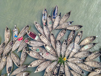 An aerial view shows wooden passenger boats along the Buriganga River in Keraniganj, Dhaka, Bangladesh, on October 13, 2024. The boats, deco...