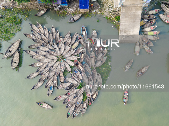 An aerial view shows wooden passenger boats along the Buriganga River in Keraniganj, Dhaka, Bangladesh, on October 13, 2024. The boats, deco...