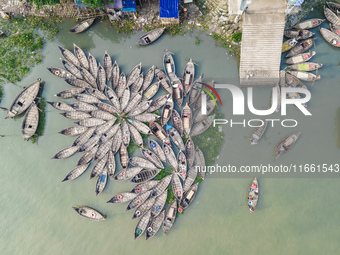 An aerial view shows wooden passenger boats along the Buriganga River in Keraniganj, Dhaka, Bangladesh, on October 13, 2024. The boats, deco...