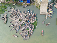 An aerial view shows wooden passenger boats along the Buriganga River in Keraniganj, Dhaka, Bangladesh, on October 13, 2024. The boats, deco...