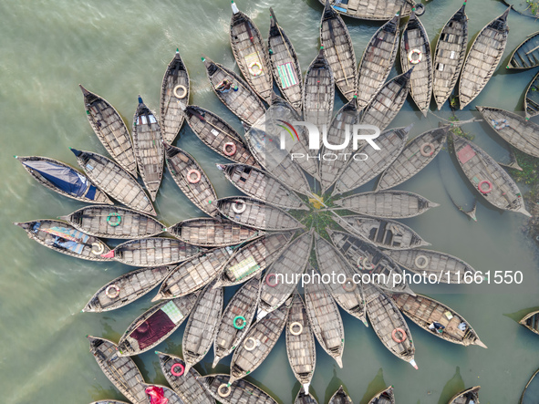 An aerial view shows wooden passenger boats along the Buriganga River in Keraniganj, Dhaka, Bangladesh, on October 13, 2024. The boats, deco...