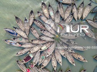 An aerial view shows wooden passenger boats along the Buriganga River in Keraniganj, Dhaka, Bangladesh, on October 13, 2024. The boats, deco...