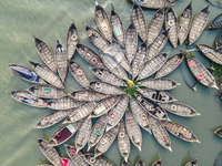 An aerial view shows wooden passenger boats along the Buriganga River in Keraniganj, Dhaka, Bangladesh, on October 13, 2024. The boats, deco...