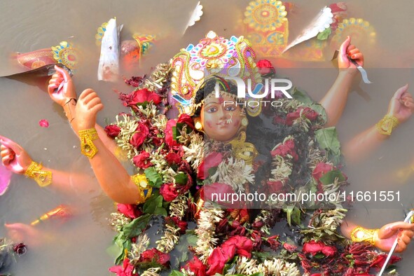 An idol of the Hindu goddess Durga floats in the river Brahmaputra after it is immersed on the last day of the Durga Puja festival in Guwaha...