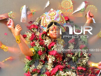 An idol of the Hindu goddess Durga floats in the river Brahmaputra after it is immersed on the last day of the Durga Puja festival in Guwaha...