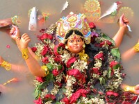 An idol of the Hindu goddess Durga floats in the river Brahmaputra after it is immersed on the last day of the Durga Puja festival in Guwaha...