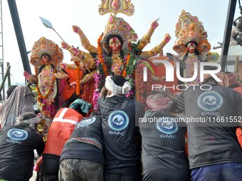 An idol of the Hindu goddess Durga is taken for immersion in the river Brahmaputra on the last day of the Durga Puja festival in Guwahati, I...