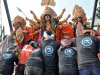 An idol of the Hindu goddess Durga is taken for immersion in the river Brahmaputra on the last day of the Durga Puja festival in Guwahati, I...