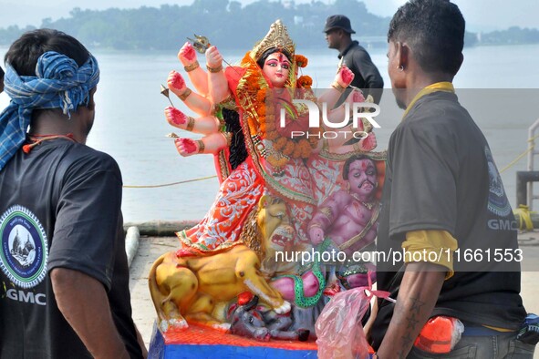 An idol of the Hindu goddess Durga is taken for immersion in the river Brahmaputra on the last day of the Durga Puja festival in Guwahati, I...