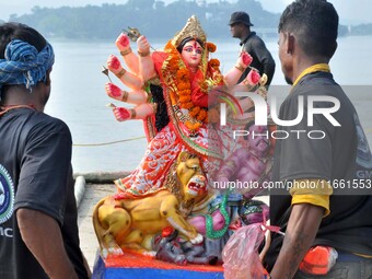 An idol of the Hindu goddess Durga is taken for immersion in the river Brahmaputra on the last day of the Durga Puja festival in Guwahati, I...