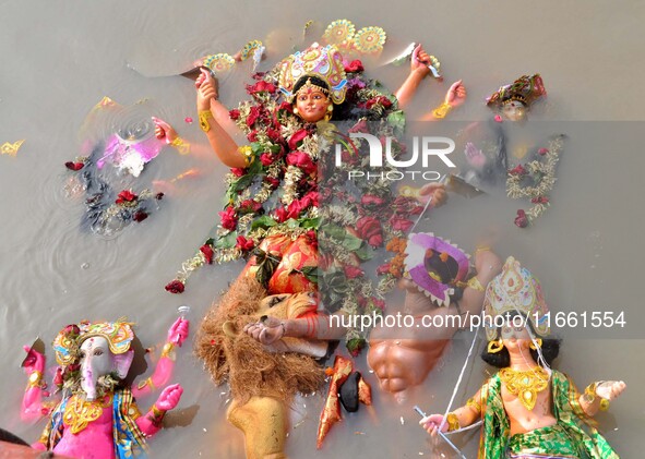 An idol of the Hindu goddess Durga floats in the river Brahmaputra after it is immersed on the last day of the Durga Puja festival in Guwaha...