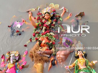 An idol of the Hindu goddess Durga floats in the river Brahmaputra after it is immersed on the last day of the Durga Puja festival in Guwaha...