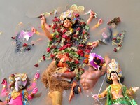 An idol of the Hindu goddess Durga floats in the river Brahmaputra after it is immersed on the last day of the Durga Puja festival in Guwaha...