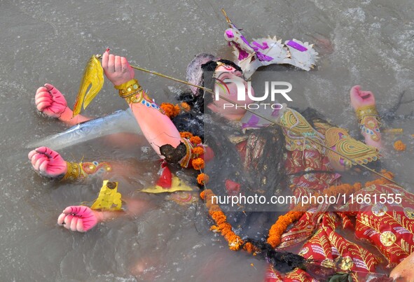 An idol of the Hindu goddess Durga floats in the river Brahmaputra after it is immersed on the last day of the Durga Puja festival in Guwaha...