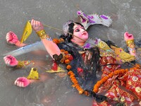 An idol of the Hindu goddess Durga floats in the river Brahmaputra after it is immersed on the last day of the Durga Puja festival in Guwaha...