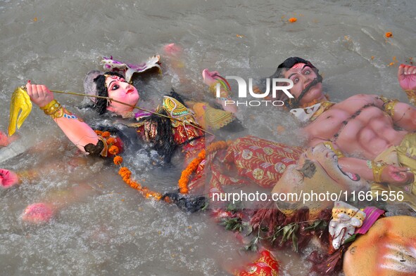 An idol of the Hindu goddess Durga floats in the river Brahmaputra after it is immersed on the last day of the Durga Puja festival in Guwaha...