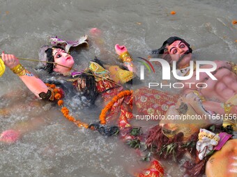 An idol of the Hindu goddess Durga floats in the river Brahmaputra after it is immersed on the last day of the Durga Puja festival in Guwaha...