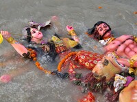 An idol of the Hindu goddess Durga floats in the river Brahmaputra after it is immersed on the last day of the Durga Puja festival in Guwaha...