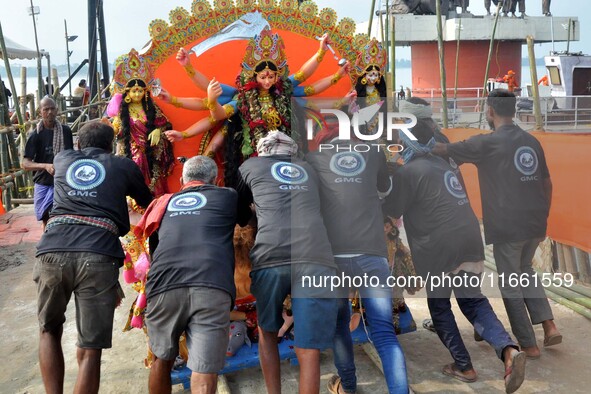 An idol of the Hindu goddess Durga is taken for immersion in the river Brahmaputra on the last day of the Durga Puja festival in Guwahati, I...