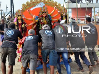 An idol of the Hindu goddess Durga is taken for immersion in the river Brahmaputra on the last day of the Durga Puja festival in Guwahati, I...