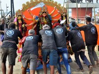 An idol of the Hindu goddess Durga is taken for immersion in the river Brahmaputra on the last day of the Durga Puja festival in Guwahati, I...