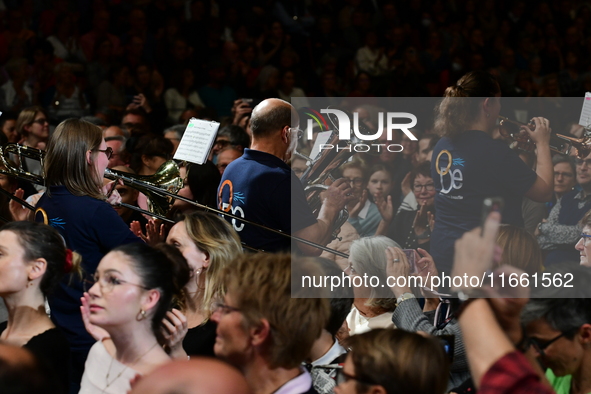 Spectators use telephones to light shows and attend a trumpet concert at the opening night of the light festival in Lyon, France, on October...