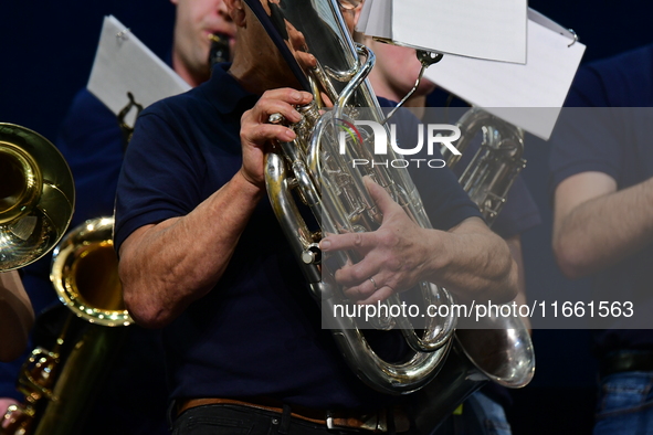 Spectators use telephones to light shows and attend a trumpet concert at the opening night of the light festival in Lyon, France, on October...