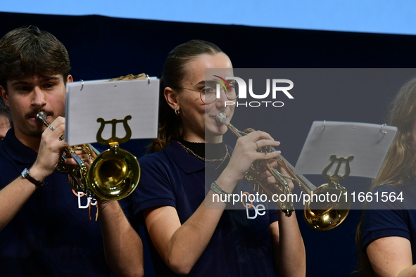 Spectators use telephones to light shows and attend a trumpet concert at the opening night of the light festival in Lyon, France, on October...