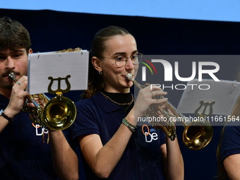 Spectators use telephones to light shows and attend a trumpet concert at the opening night of the light festival in Lyon, France, on October...