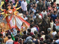 Hindu devotees immerse a clay idol of the Hindu goddess Durga in the Buriganga River on the final day of the Durga Puja festival in Dhaka, B...