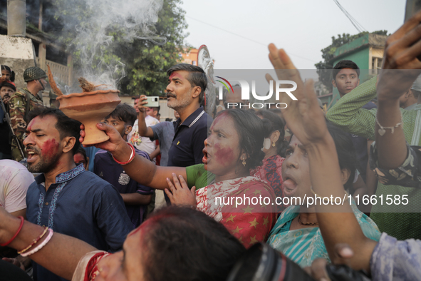 A Hindu devotee performs a singing ritual during the Durga Puja festival in Dhaka, Bangladesh, on October 13, 2024. 