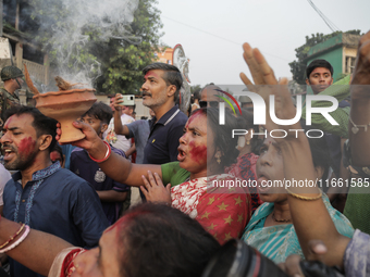 A Hindu devotee performs a singing ritual during the Durga Puja festival in Dhaka, Bangladesh, on October 13, 2024. (