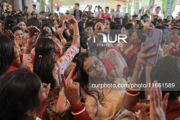 A Hindu devotee dances to celebrate the Durga Puja in Dhaka, Bangladesh, on October 13, 2024. 