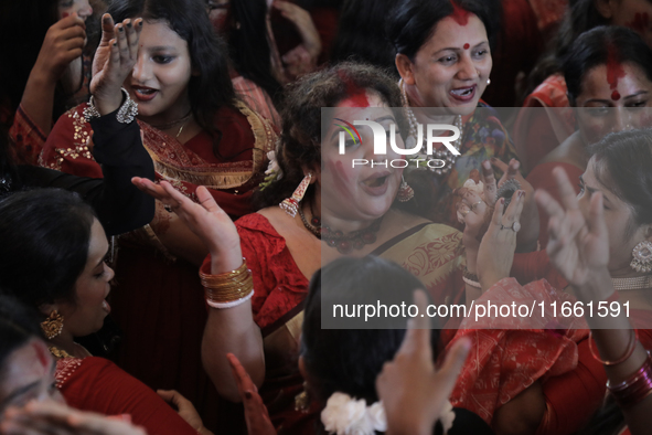 A Hindu devotee dances to celebrate the Durga Puja in Dhaka, Bangladesh, on October 13, 2024. 