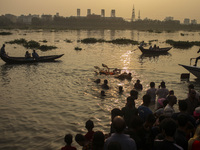 Hindu devotees immerse a clay idol of the Hindu Goddess Durga in the Buriganga River on the final day of the 'Durga Puja' festival in Dhaka,...