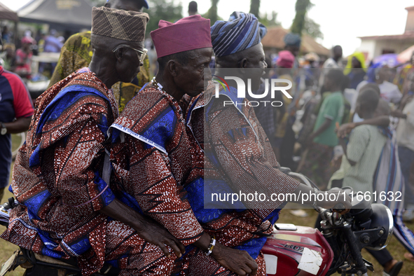 Three men on a motorcycle depart at the end of the 2024 edition of the annual World Twins Festival held in Igbo-Ora, Nigeria, on October 12,...