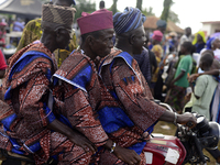 Three men on a motorcycle depart at the end of the 2024 edition of the annual World Twins Festival held in Igbo-Ora, Nigeria, on October 12,...