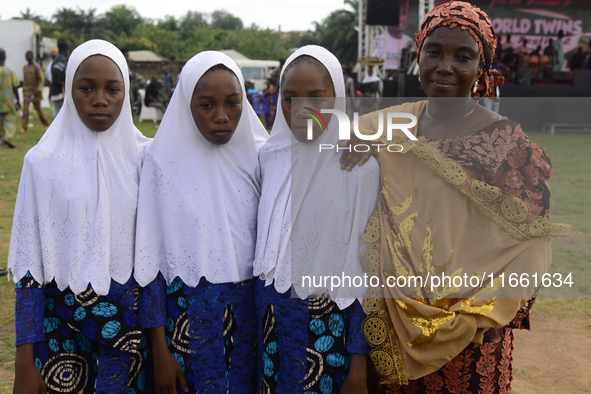 Mrs. Saadat Ismail (R) poses with her triplets, Anida (2nd R), Abiba (2nd L), and Amira, during the 2024 edition of the annual World Twins F...